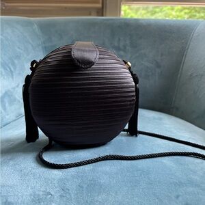 Sleek Black Mini Round Bag with Textured Design